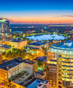 Orlando, Florida, USA aerial cityscape towards Lake Eola at dusk.